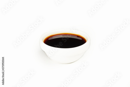 Soy sauce in a white saucer on a white plate. For the restaurant menu. Traditional Chinese classic soy sauce. Sushi, Japanese cuisine