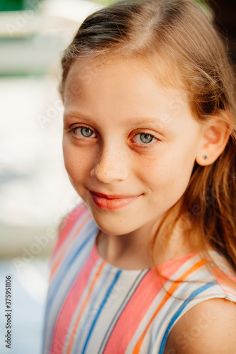 close up. beautiful girl with freckles. clean and healthy skin. happy childhood. summer.