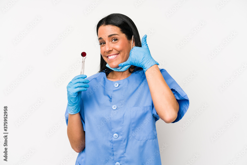 Dentist woman isolated on white background showing a mobile phone call gesture with fingers. Dentist woman isolated on white background showing a mobile phone call gesture with fingers.