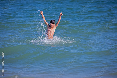 happy boy squirts in the open sea, horizontal format