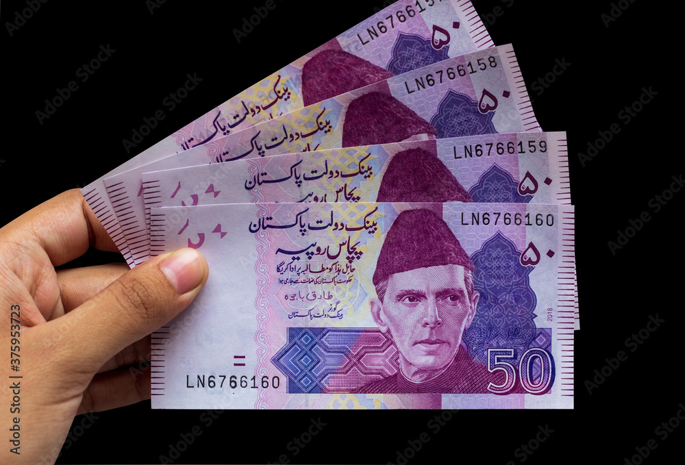 Pakistani 50 Note hold in hand closeup, Isolated on black background