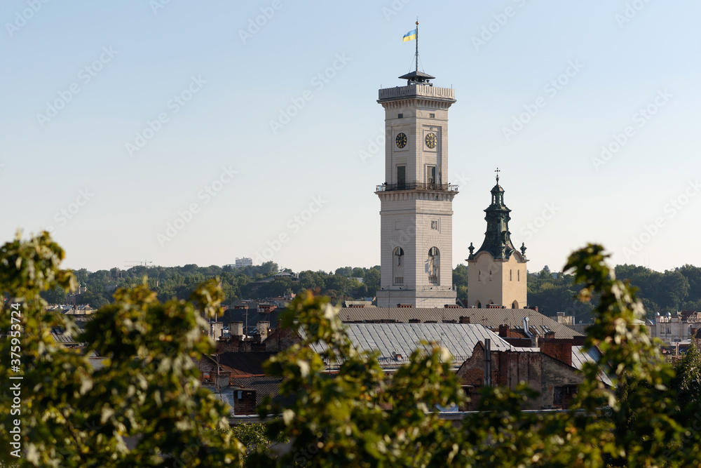 Panoramic view in sunny weather on the city hall and the tower of the Latin Cathedral in the city of Lviv in Ukraine.