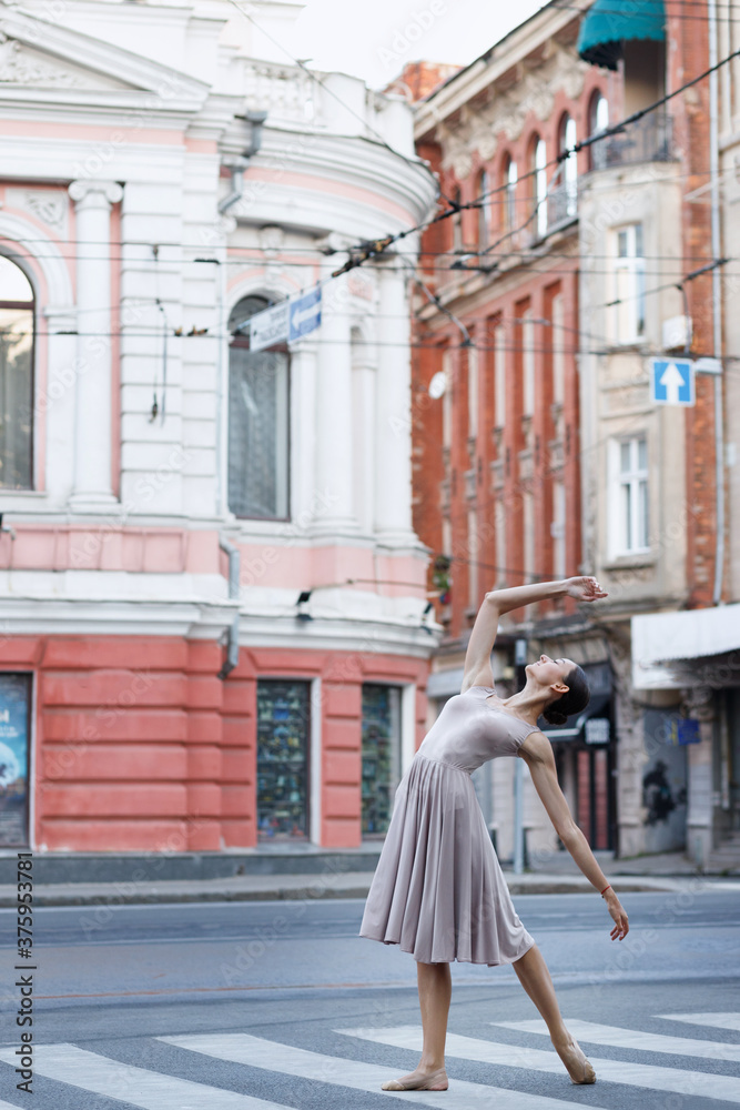 Ballerina dances to the music in the city