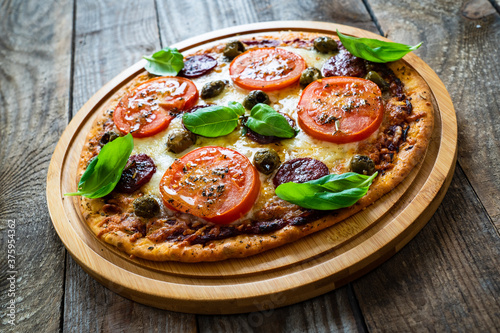 Margherita pizza on wooden background 
