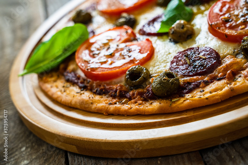 Margherita pizza on wooden background
