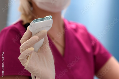 Medical ultrasound equipment in the clinic. Close-up of a scanner covered with ultrasound gel in the doctor's hands. Health and beauty concept.