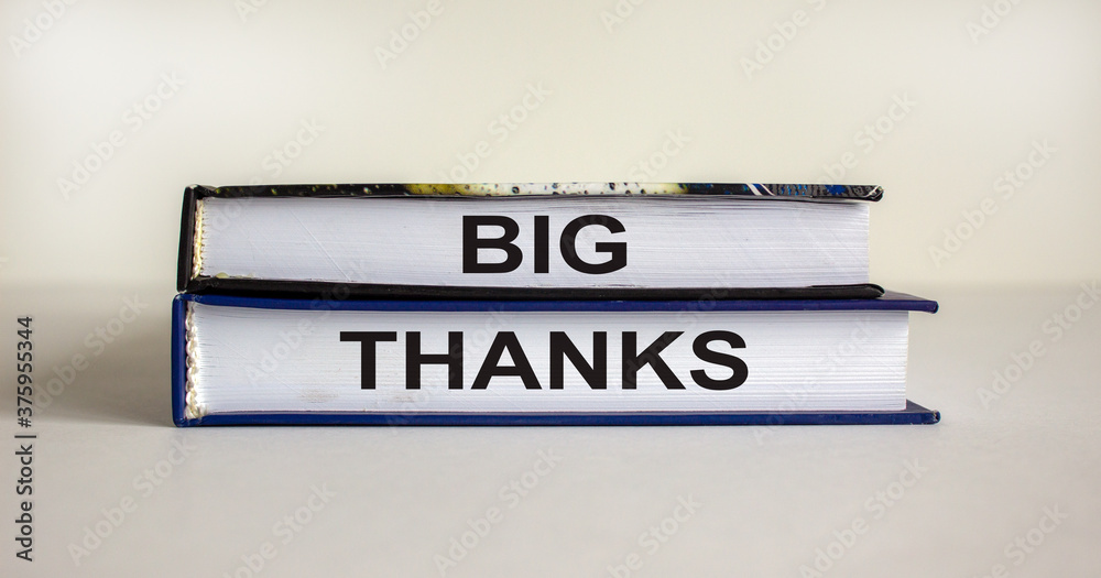 Books with text 'big thanks' on beautiful white table. White background. Business concept. Copy space.