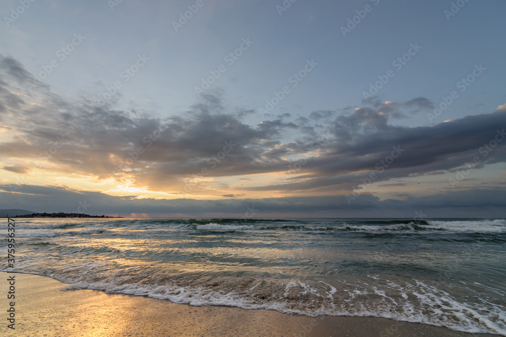 Beautiful morning landscape of the Black Sea coast of Bulgaria with waves at sunrise