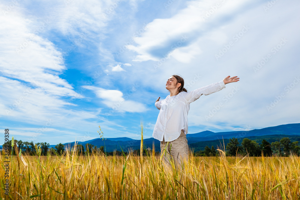 Girl holding arms up against blue sky
Girl holding arms up against blue sky