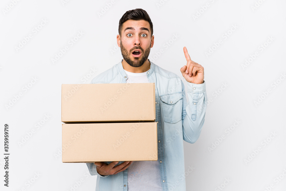Young caucasian man moving to a new home isolated having some great idea, concept of creativity. Young caucasian man moving to a new home isolated having some great idea, concept of creativity.
