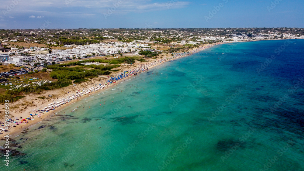 Aerial view of the Pescoluse Beach, aka Maldives of Salento, in the south of Italy - Apulian beach with turquoise waters in summer - Idyllic holiday destination along the Ionian Sea
