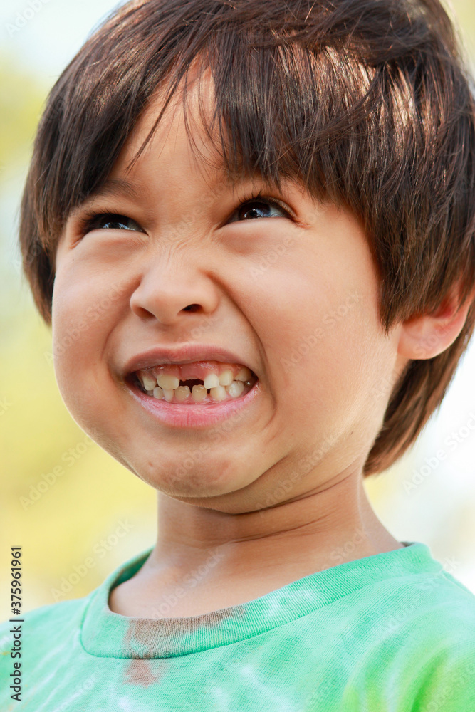 A young boy missing a tooth is making a silly face. A young boy missing a tooth is making a silly face.