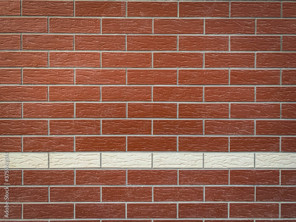 Obraz premium Background modern red brick wall with one line of white bricks