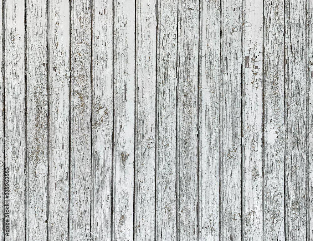 White rustic wooden peeling planks with cracks and scratches background White rustic wooden peeling planks with cracks and scratches background