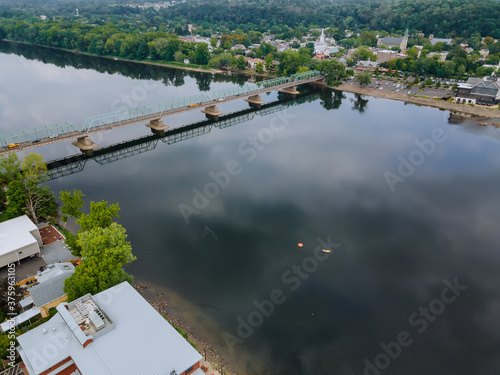 The view of aerial Delaware river, bridge across the in the historic city New Hope Pennsylvania and Lambertville New Jersey USA photo