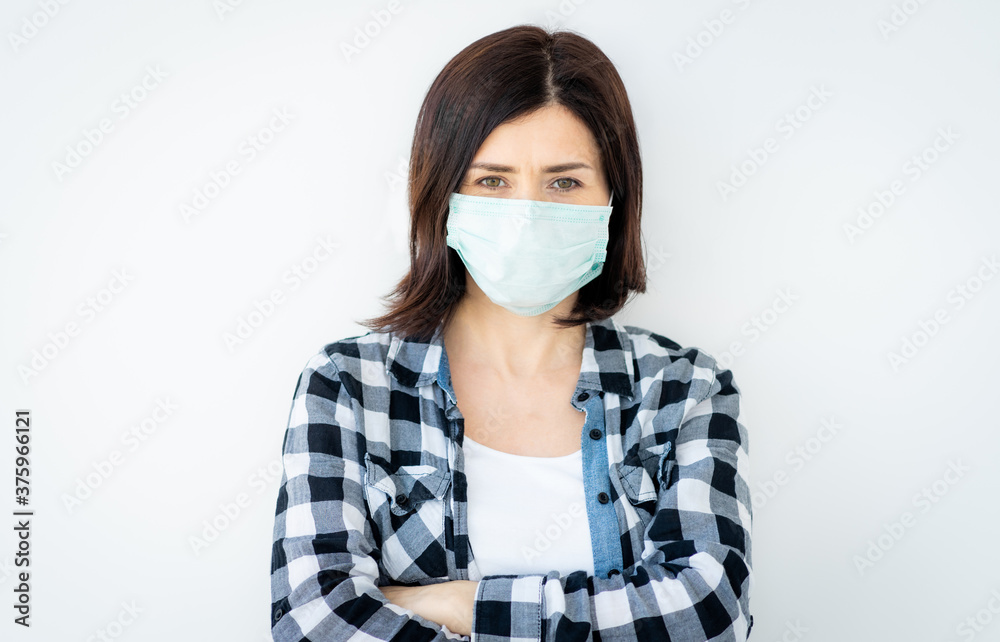 Beautiful woman wearing medical mask isolated on white background Beautiful woman wearing medical mask isolated on white background