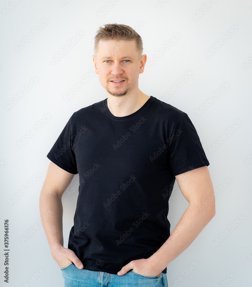 Fototapeta premium Happy man wearing black shirt with copy space