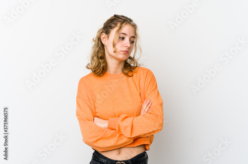 Young caucasian woman on white backrgound tired of a repetitive task.