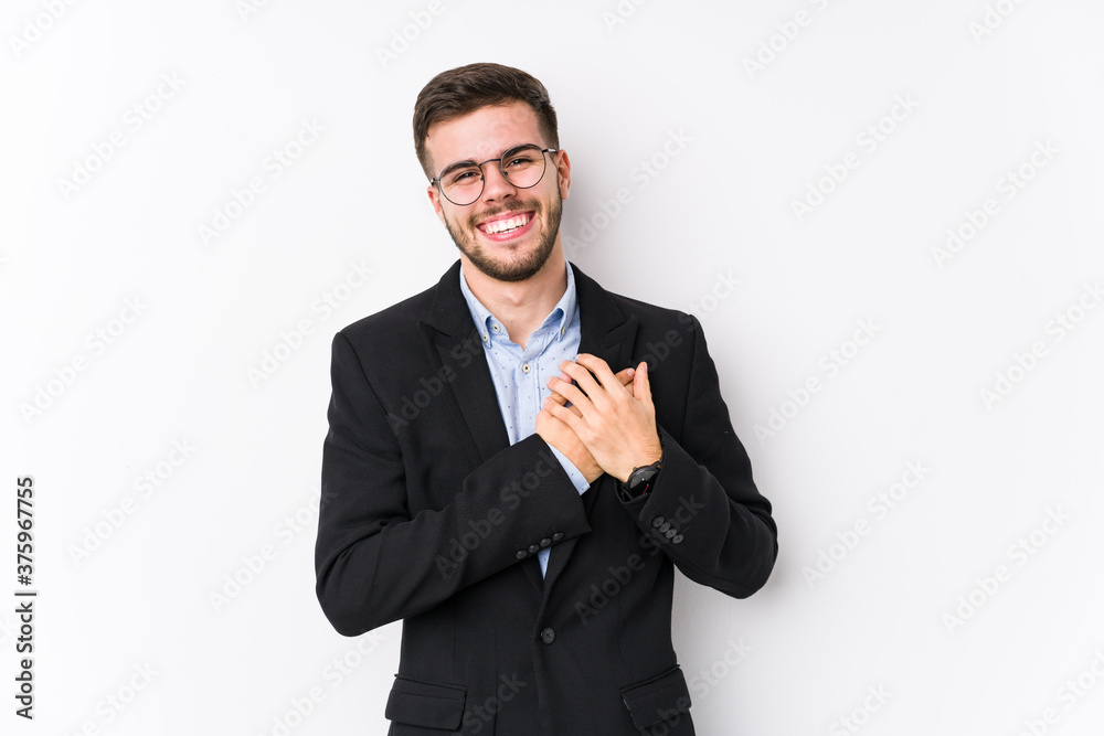 Young caucasian business man posing in a white background isolated Young caucasian business man laughing keeping hands on heart, concept of happiness. Young caucasian business man posing in a white background isolated Young caucasian business man laughing keeping hands on heart, concept of happiness.