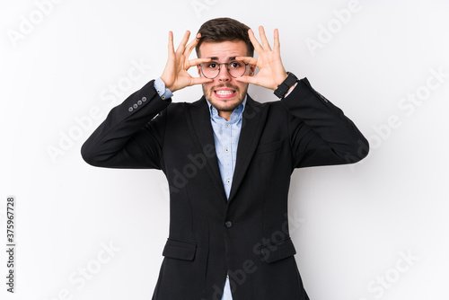 Young caucasian business man posing in a white background isolated Young caucasian business man keeping eyes opened to find a success opportunity.