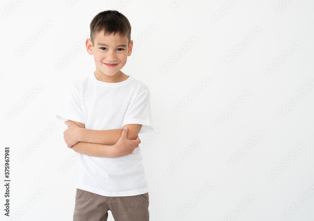 Smiling little boy with crossed hands in white t-shirt Smiling little boy with crossed hands in white t-shirt