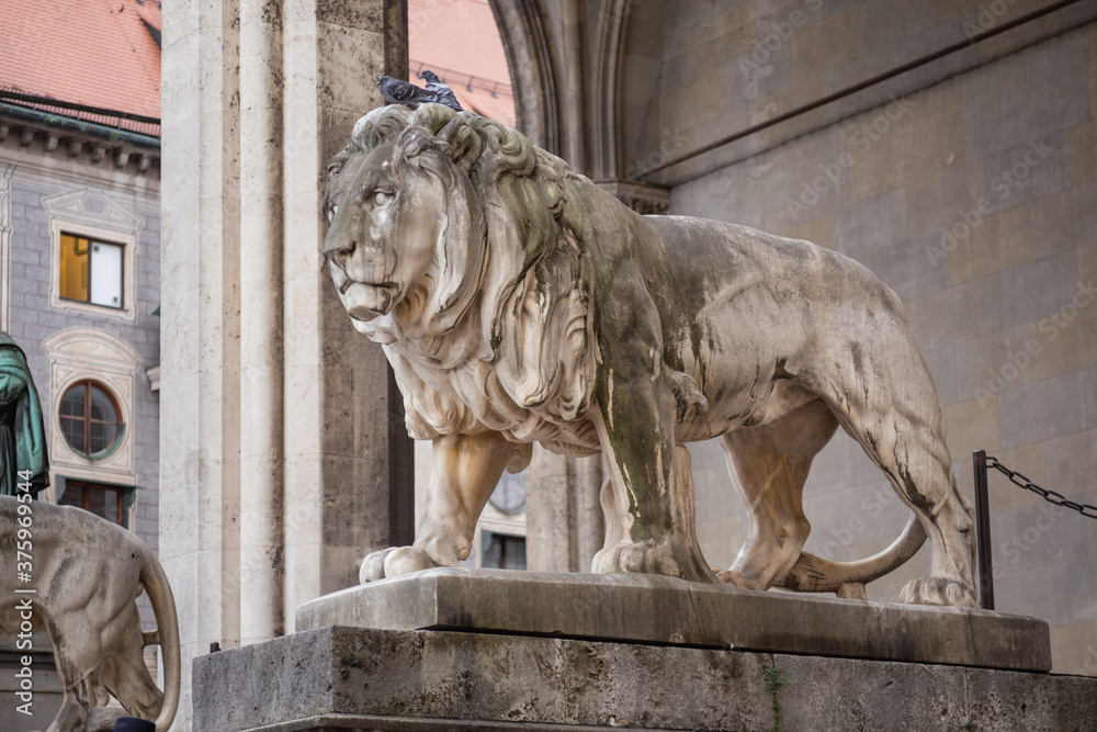 statue of a lion made of stone on a pedestal in Munich