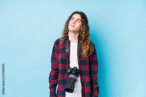 Young caucasian photographer man isolated dreaming of achieving goals and purposes