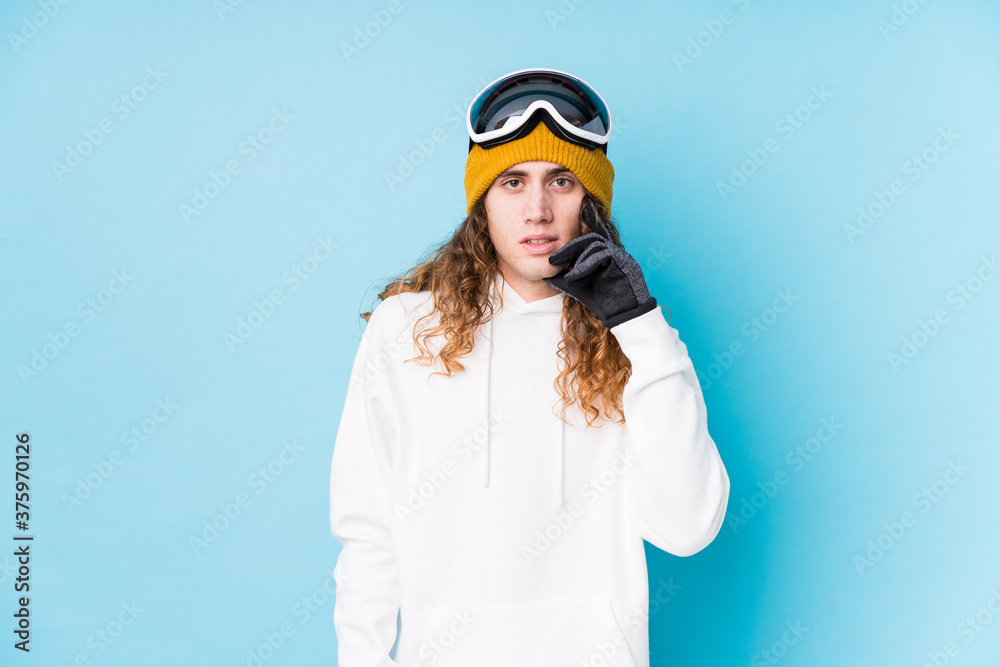 Young caucasian man wearing a ski clothes isolated biting fingernails, nervous and very anxious. Young caucasian man wearing a ski clothes isolated biting fingernails, nervous and very anxious.