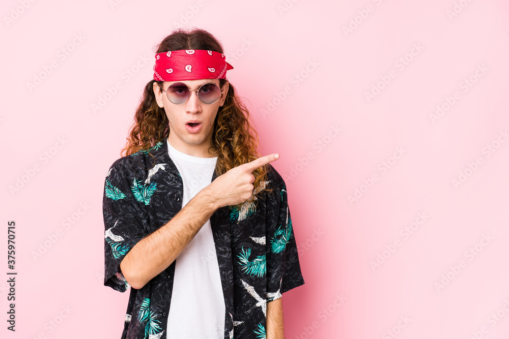 Young hippie caucasian man isolated pointing to the side