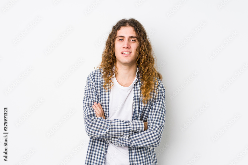 Young long hair man posing isolated laughing and having fun. Young long hair man posing isolated laughing and having fun.