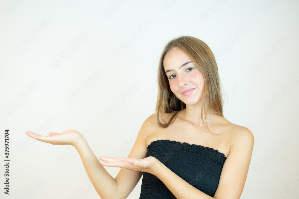 Smiling beautiful girl in black top showing something