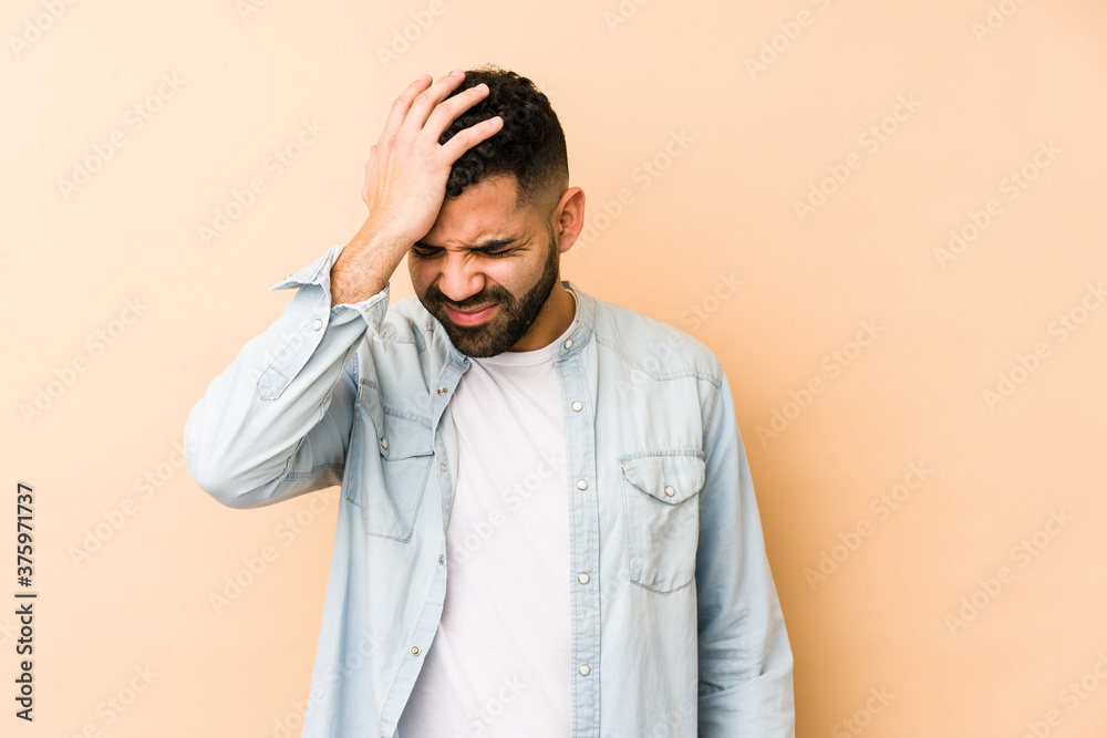 Young mixed race arabic man isolated forgetting something, slapping forehead with palm and closing eyes.