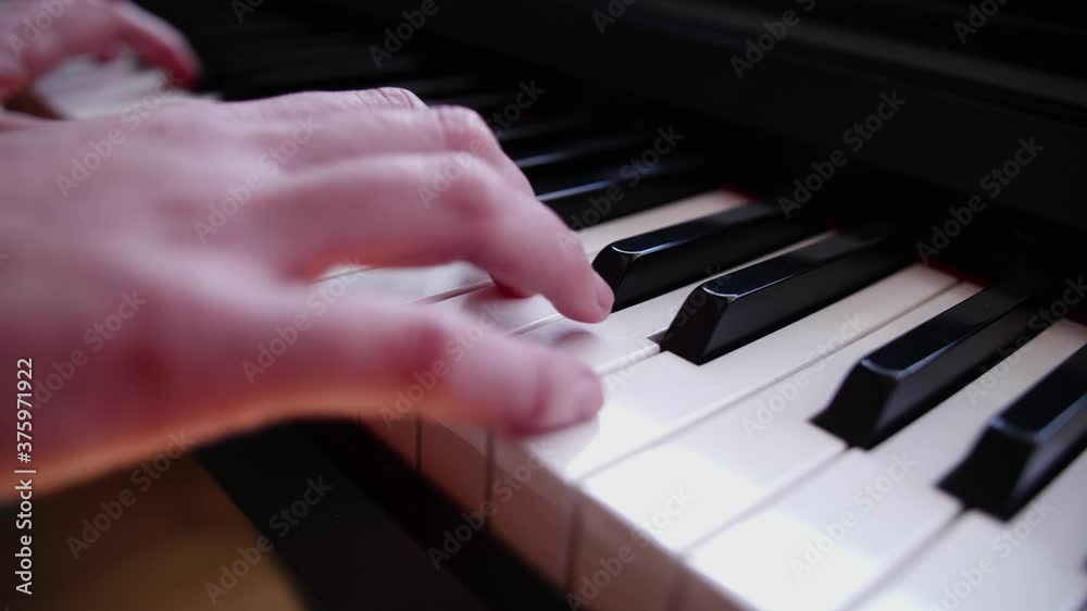 Close up of the hands of a young woman playing piano Close up of the hands of a young woman playing piano