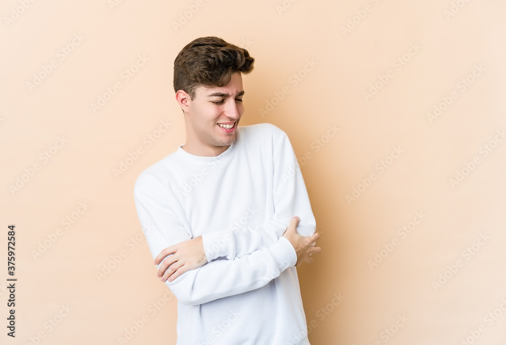 Young caucasian man isolated on beige background smiling confident with crossed arms. Young caucasian man isolated on beige background smiling confident with crossed arms.