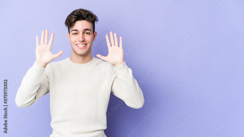 Young caucasian man isolated on purple background showing number ten with hands. Young caucasian man isolated on purple background showing number ten with hands.