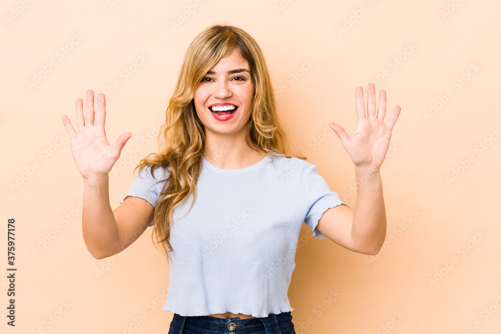 Young blonde caucasian woman showing number ten with hands. Young blonde caucasian woman showing number ten with hands.