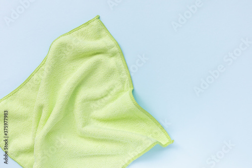 Yellow microfiber cloth for cleaning. Cleaning micro fabric towels for dusting and polishing. Domestic household cleaning service concept. Close up, copy space