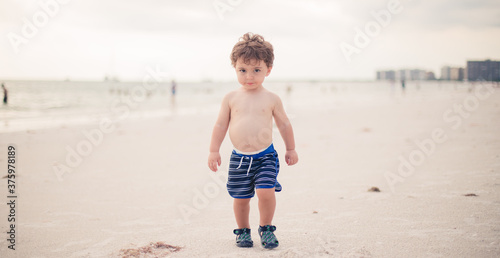 little boy running on the beach in Marco island florida gulf of mexico 