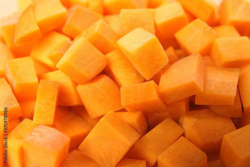 Cubes of fresh ripe carrots as background, closeup Cubes of fresh ripe carrots as background, closeup
