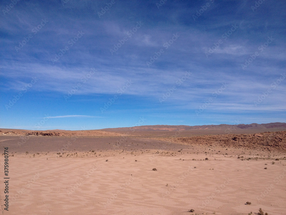 desert sand blue sky clouds