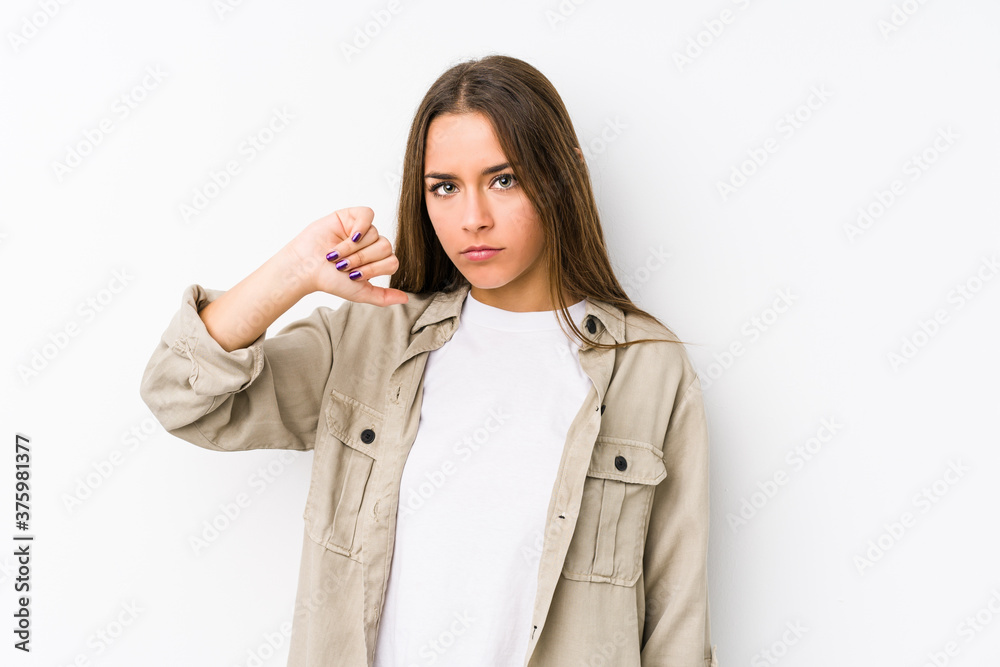 Young caucasian woman isolated showing a dislike gesture, thumbs down. Disagreement concept. Young caucasian woman isolated showing a dislike gesture, thumbs down. Disagreement concept.