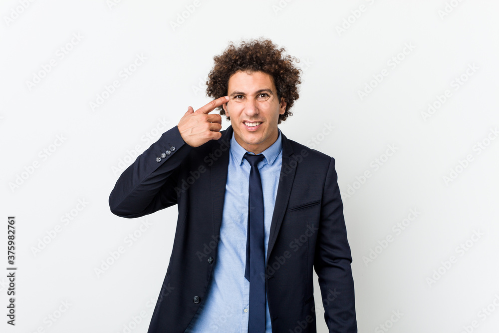 Young business curly man against white background showing a disappointment gesture with forefinger. Young business curly man against white background showing a disappointment gesture with forefinger.