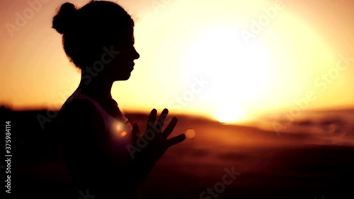 girl standing in front of sun - goldy photo