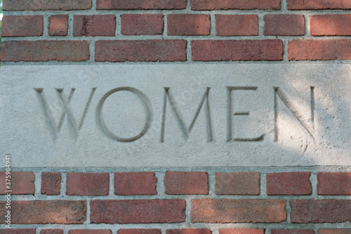 woman wall cement brick sign