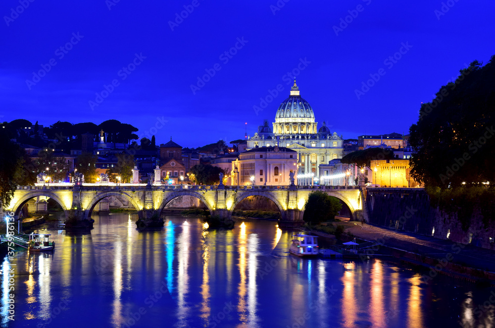 Saint Peter Cathedral and bridge at night in Rome, Italy
