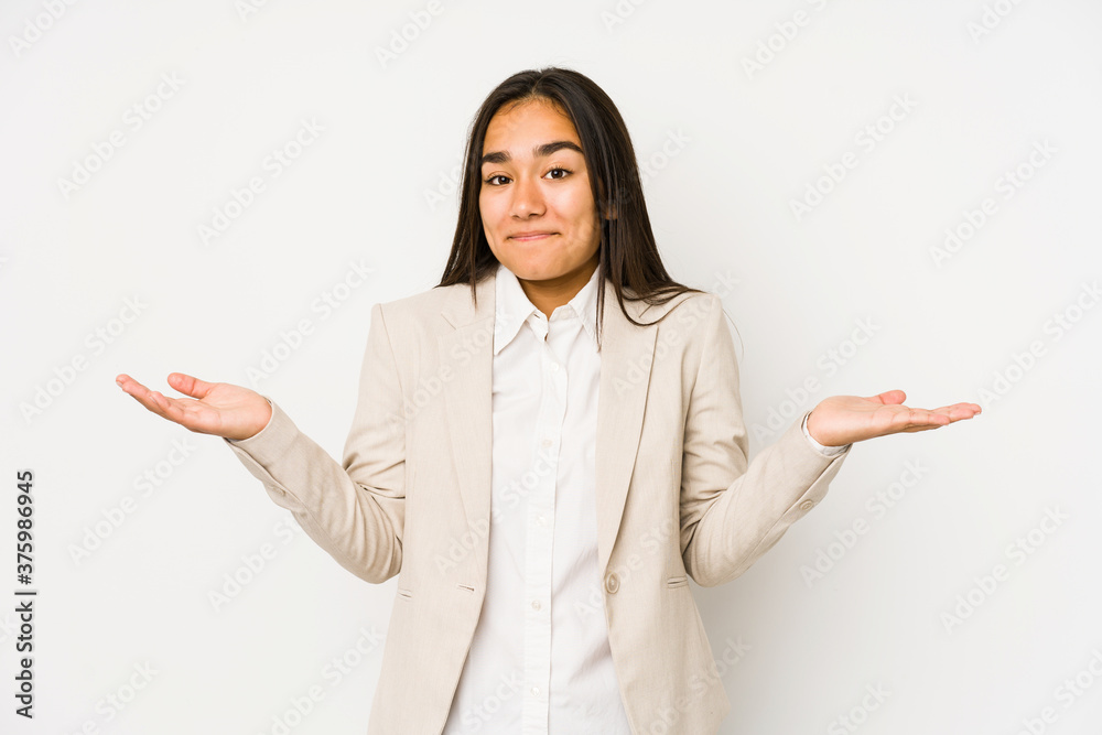 Young woman isolated on a white background doubting and shrugging shoulders in questioning gesture. Young woman isolated on a white background doubting and shrugging shoulders in questioning gesture.