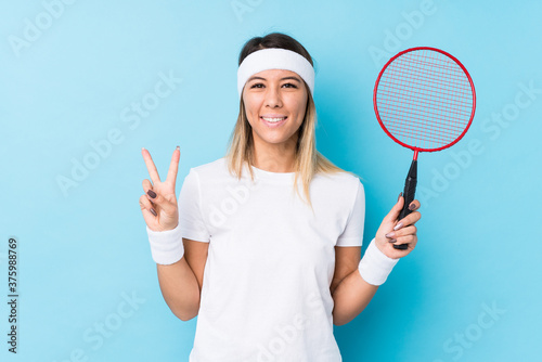 Young caucasian woman playing badminton isolated showing number two with fingers. © Asier