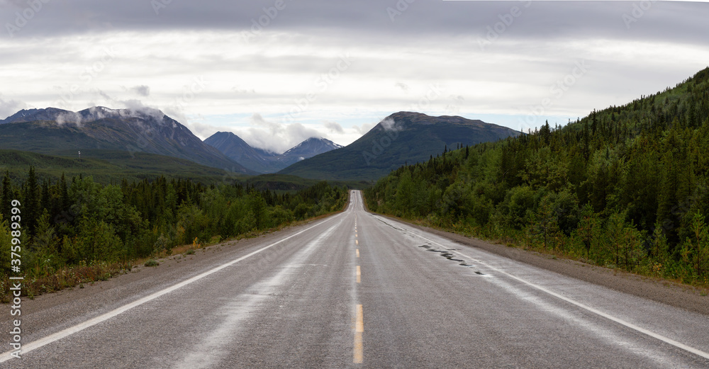 Beautiful Panoramic View of a scenic road in the Northern Rockies during a sunny and cloudy morning. Taken in British Columbia, Canada. Nature Background Panorama