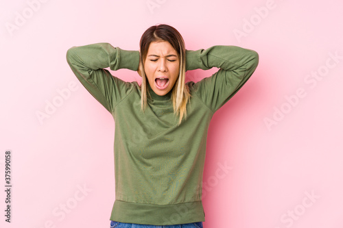 Young caucasian woman posing isolated  covering ears with hands trying not to hear too loud sound.