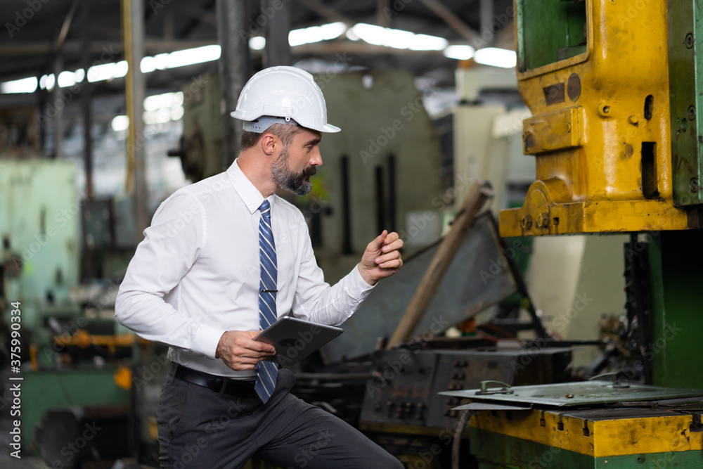 Man at work. Mechanical Engineer Bearded man in Hard Hat in Heavy Industry Manufacturing Facility. Professional Engineer Operating lathe Machinery Man at work. Mechanical Engineer Bearded man in Hard Hat in Heavy Industry Manufacturing Facility. Professional Engineer Operating lathe Machinery